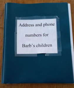 three hole plastic binder with name, address and phone numbers on each page