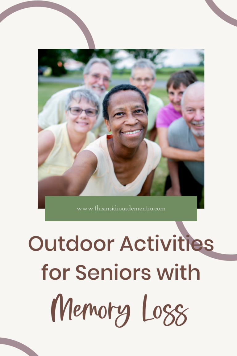 group of older citizens outside in park area smiling into camera