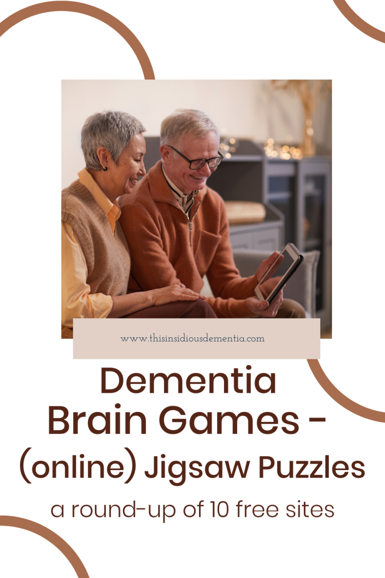 2 older people sitting and looking at a tablet that the man is holding