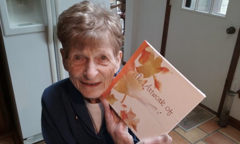 Mom showing shrink wrapped new photo book